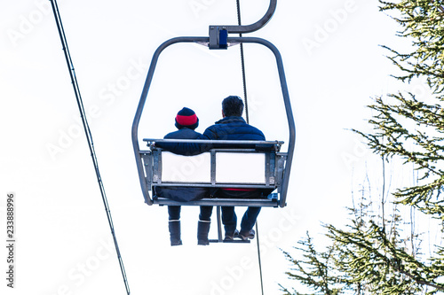 Cable car with two people going up on funicular in Sierra Nevada mountains