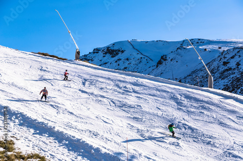 Skiers on mountainside of Sierra Nevada mountain in Spain region