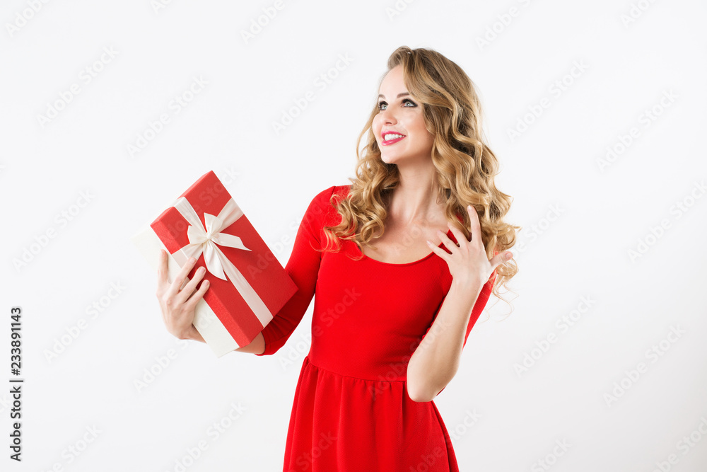 Excited cute girl in red dress holding present box. Excited cute girl in red dress holding present box.