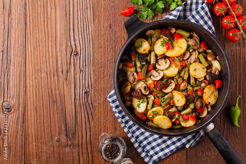 Fried pan vegetables, with mushrooms and dried tomatoes. Seasoned with a mix of herbs.