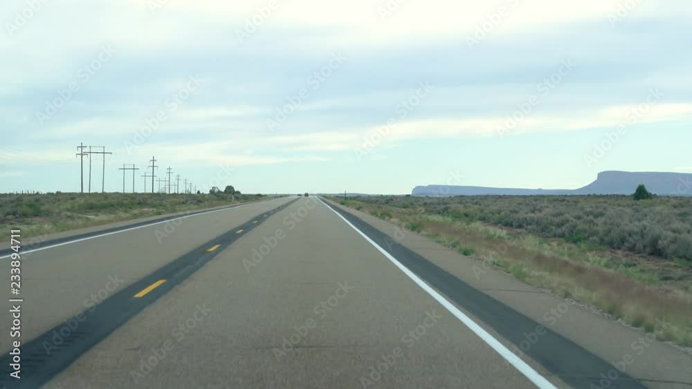 america road trip in Autumn. empty highway with mountains and green grass in background in cold weather. car driving through beautiful nature view. america road trip in Autumn. empty highway with mountains and green grass in background in cold weather. car driving through beautiful nature view.