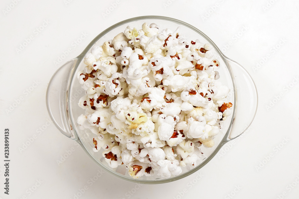 Popcorn in a transparent plate  isolated on white background