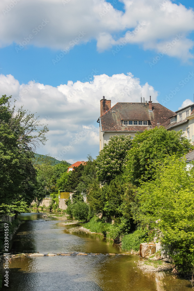 houses and trees on the banks of the Muhlbach stream in Baden. Austria