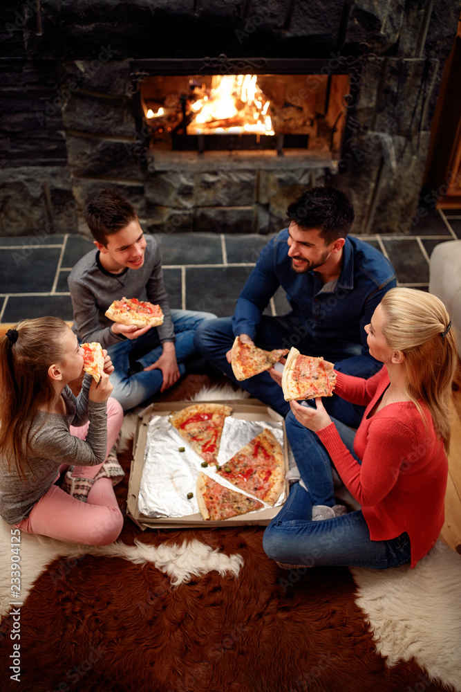 Family eating pizza together, overhead view