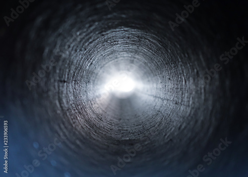 Inside view of a round plastic pipe. Tunnel to the light from the dark