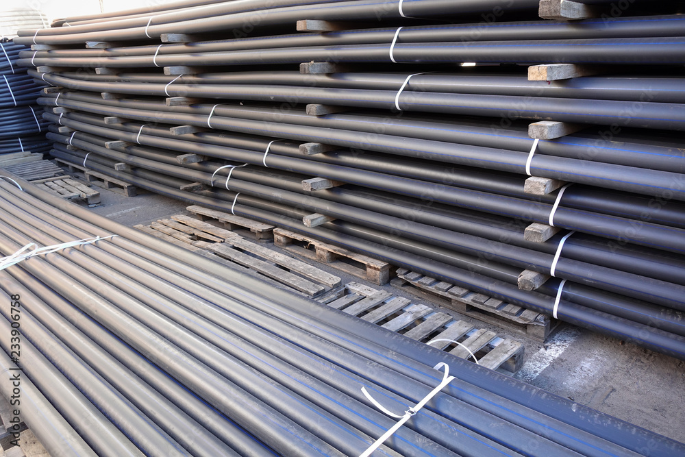 Plastic pipes in stock of finished products stacked in packs Plastic pipes in stock of finished products stacked in packs