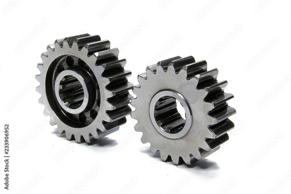 Metal gears isolated above white background. Car parts on white background. Metal gears isolated above white background. Car parts on white background.