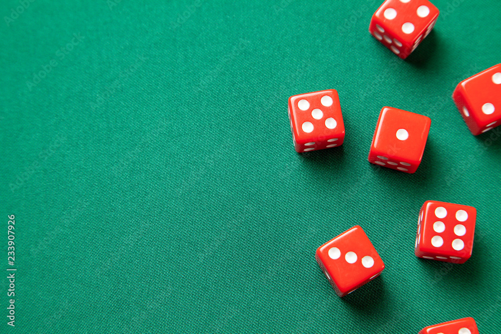 Red dices on green poker gaming table in casino. Concept online gambling. Copy space for text Red dices on green poker gaming table in casino. Concept online gambling. Copy space for text
