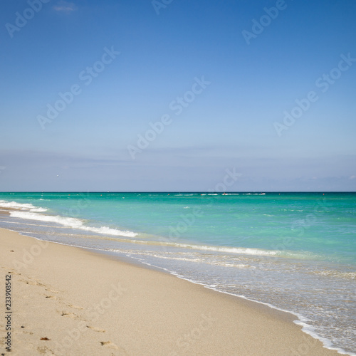 Closeup of Empty ocean sandy beach. Beach in Miami, Florida. Clear blue sky. Seaside.