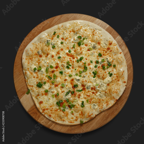 Appetizing pizza on a wooden board on a dark background. Classic feed.