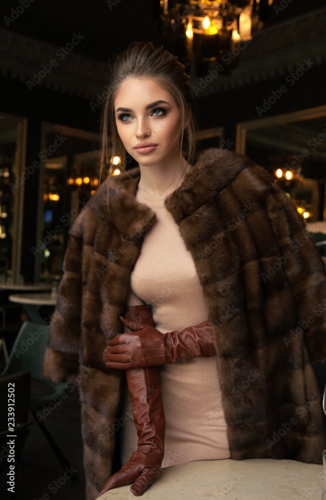 Bidrag eksplicit fungere beautiful woman with dark hair in luxurious fur coat and leather gloves  posing in restaurant Stock Photo | Adobe Stock