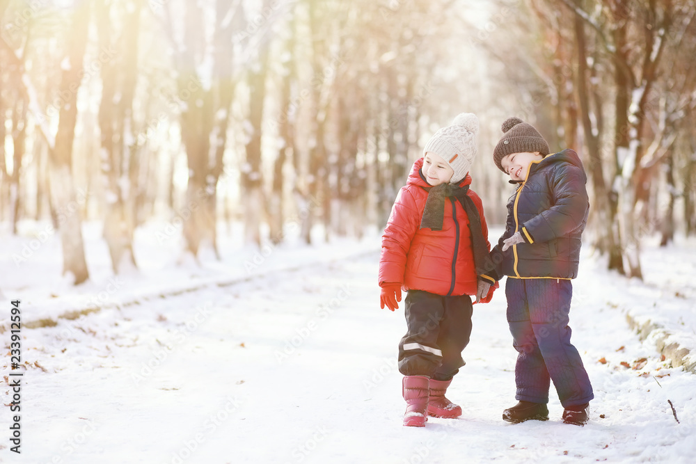 Children in winter park play Children in winter park play