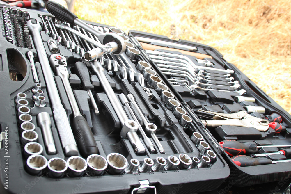 Fototapeta premium Suitcase repair tools for machinery and equipment. Hazelnuts, nozzles, hammer and more