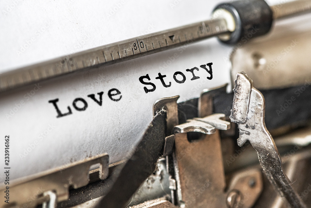 Love story typed words on a vintage typewriter. Close up