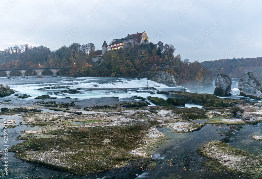 evening light panorama landscape of the Rhine Falls and Laufen castle in Switzerland with very low water level in late autumn