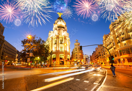 night cityscape at Calle de Alcala and Gran Via with fireworks, Madrid, Spain
