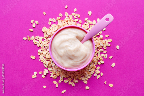 Bowl of baby porridge on pink, from above photo