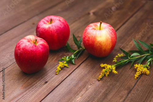 Large juicy red apples on a beautiful wooden table