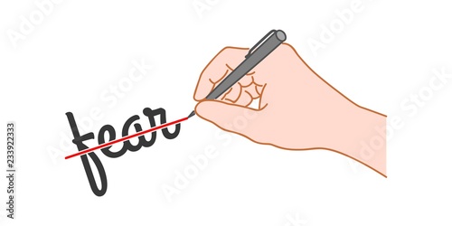 Hand with a pen crossed out the word "fear".