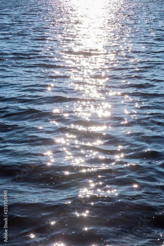 Background shot of sea water surface. glare of the sun on the surface of the water.