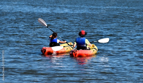 People enjoying the day kayaking at ocean beach area Florida, USA