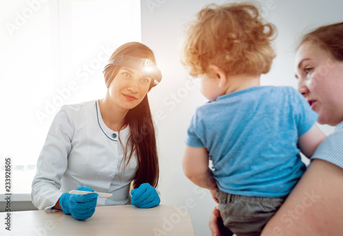 Otolaryngologist examines little boy. Medical equipment