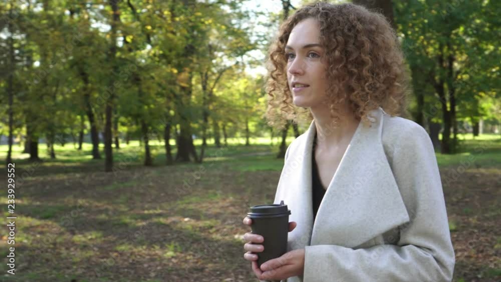 Autumn, business woman drinks coffee in the autumn park. Autumn, business woman drinks coffee in the autumn park.