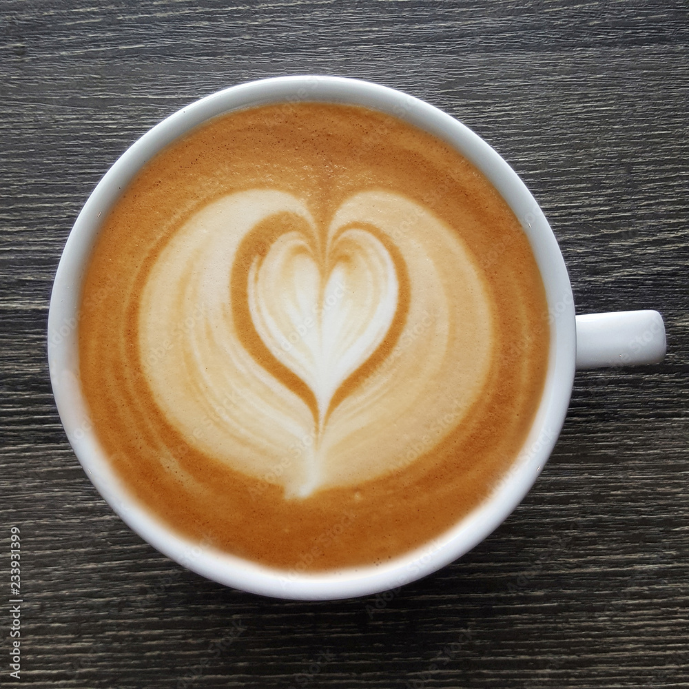 Top view of a mug of latte art coffee on black background. Top view of a mug of latte art coffee on black background.