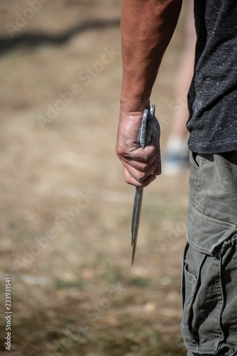 A man is ready for throwing a knife on competition.