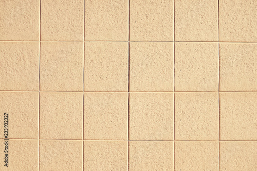Old beige mosaic wall background texture
