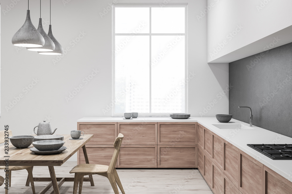 Fototapeta premium White and gray kitchen with table, side view