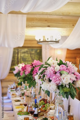 Wedding decoration of the holiday table of white and pink peonies.