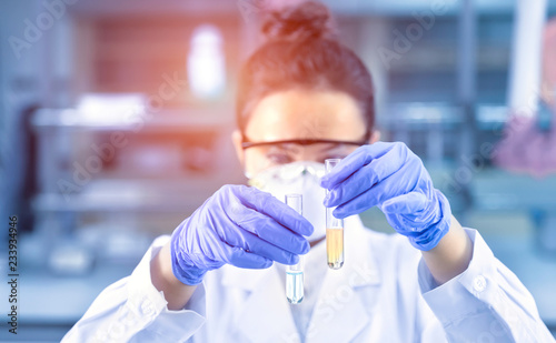 Female scientist looking at the scientific sample in the CDC laboratory