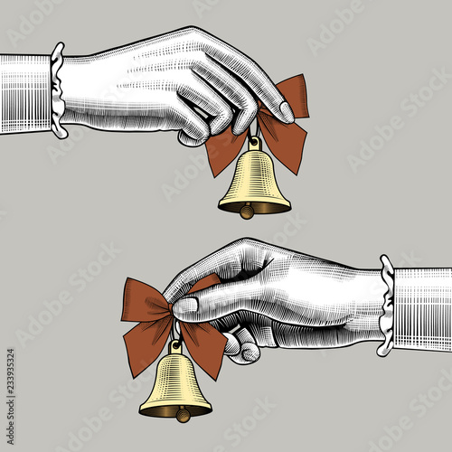 Female hands holding retro bells with red bows