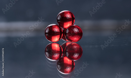 Small red medicine capsules containing nitroglycerin, validol photo