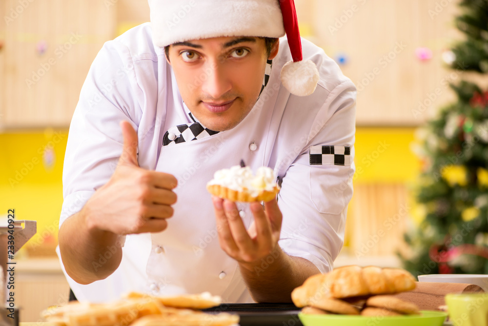 Young chef husband working in kitchen at Christmas eve Young chef husband working in kitchen at Christmas eve