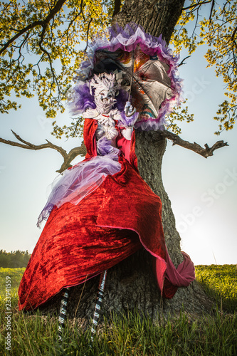 Fairy tale woman on stilts in bright fantasy stylization. Fine art outdoor photo. 