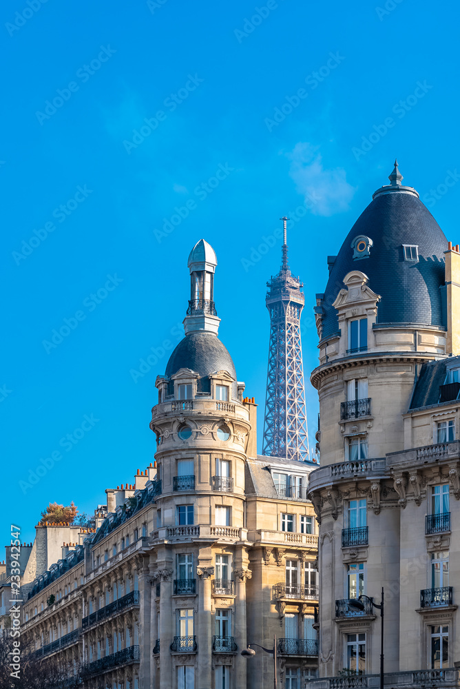 Paris, beautiful buildings, typical facades, with the Eiffel Tower in background 