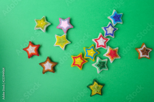 Christmas New Yearstar stars different colors made from beads handmade on green background