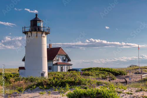 Race Point Light Lighthouse in sand dunes on the beach at Cape Cod, New England, Massachusetts, USA. photo