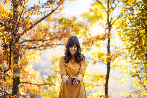 Pretty woman enjoying autumn day,playing with leaves © Novak