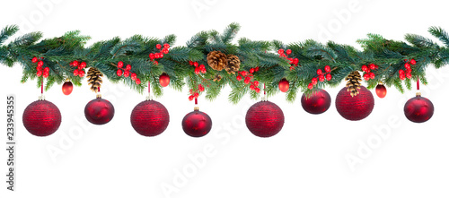 Christmas garland with red hanging balls and berries on isolated white background