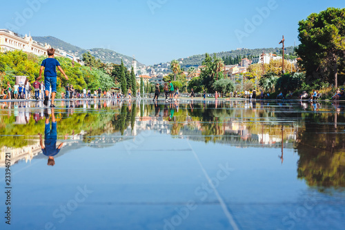Nice, France August 11, 2018: Children playing in the water park photo