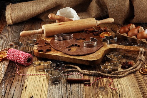 Baking ingredients for homemade pastry on wooden background with cookies and spieces photo