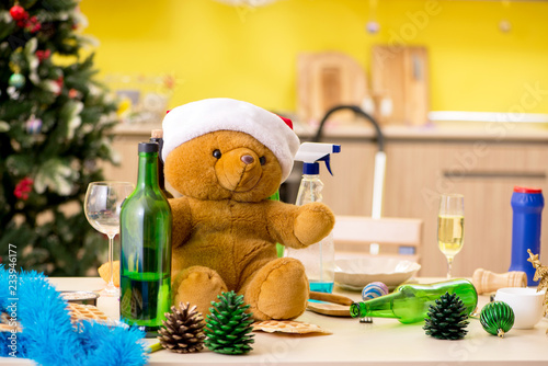 Young man cleaning kitchen after Christmas party  photo