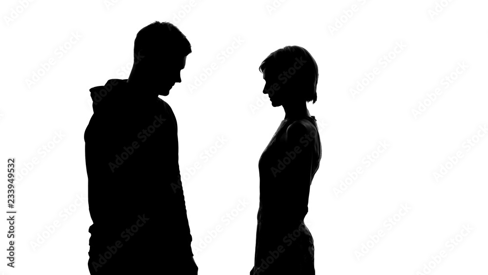 Silhouettes of young male and female on white background looking at each other