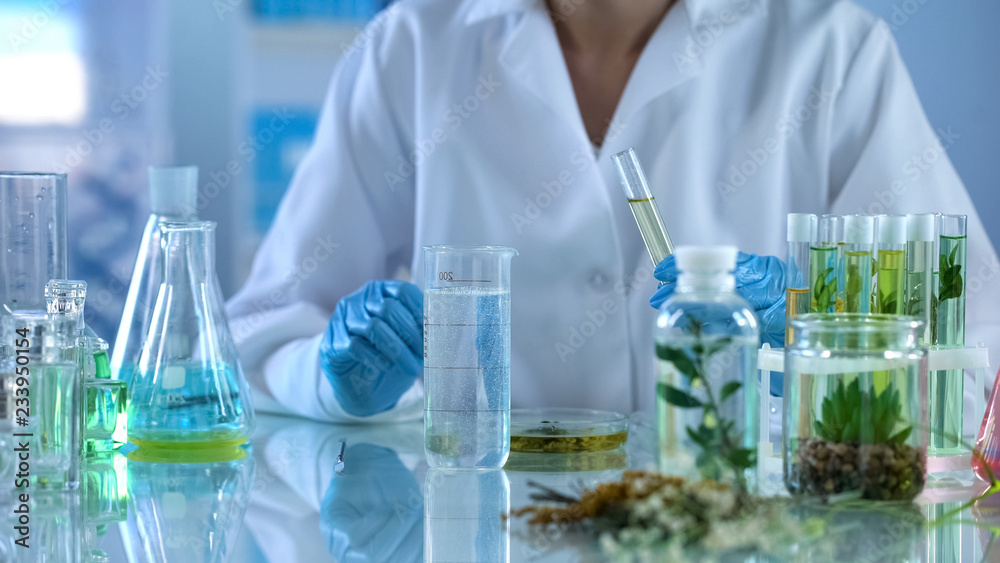 Chemist experimenting with cosmetic liquids, body care product, cosmetology