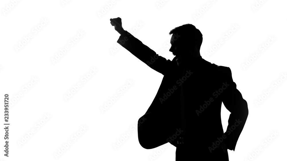 Man silhouette raising fists up, celebrating victory, good bargain, side view
