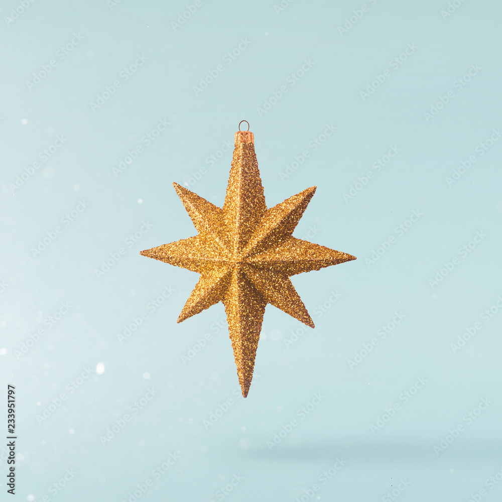 Christmas concept. Creative Christmas conception made by falling in air gold bright star Christmas concept. Creative Christmas conception made by falling in air gold bright star