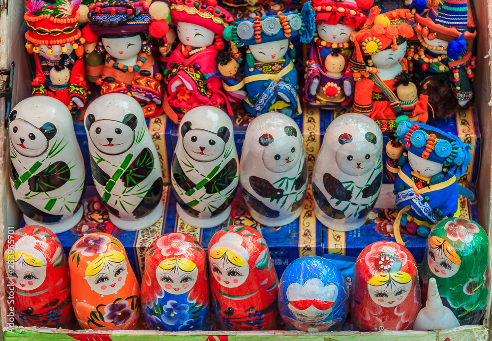 Chinese dolls and Russian matryoshka along with stylized panda bear nesting toys on display at a souvenir shop by the Great Wall of China in Mutianyu village, near Beijing